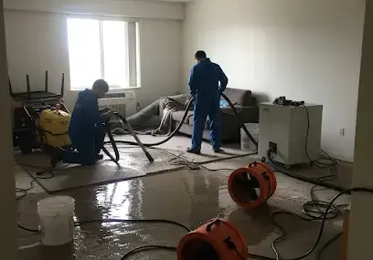 Air movers drying a wet floor in a Metairie home after a water loss