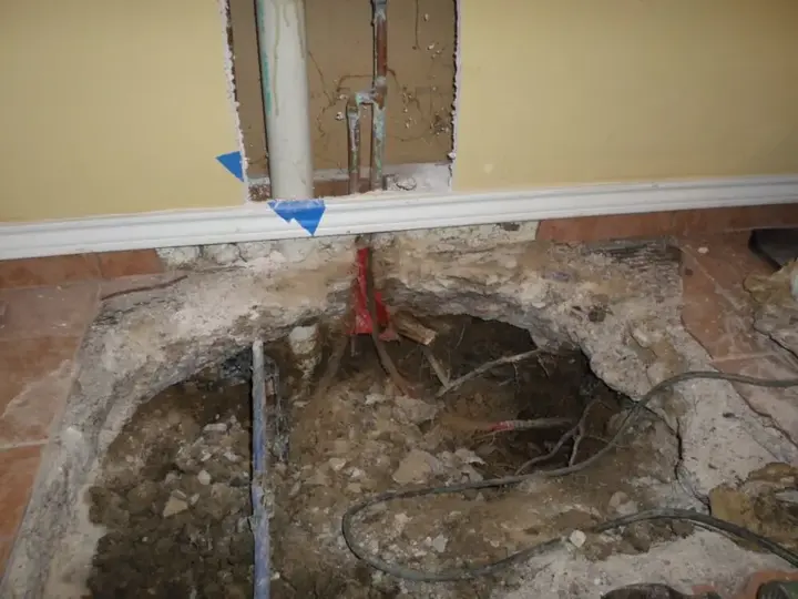 Wet flooring pulled up over a slab leak in a Metairie, LA home